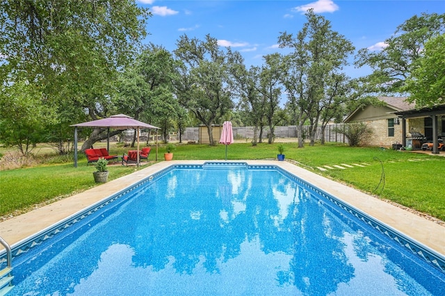 view of pool featuring a yard