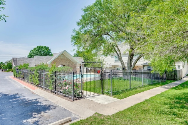 view of home's community featuring a swimming pool and a yard