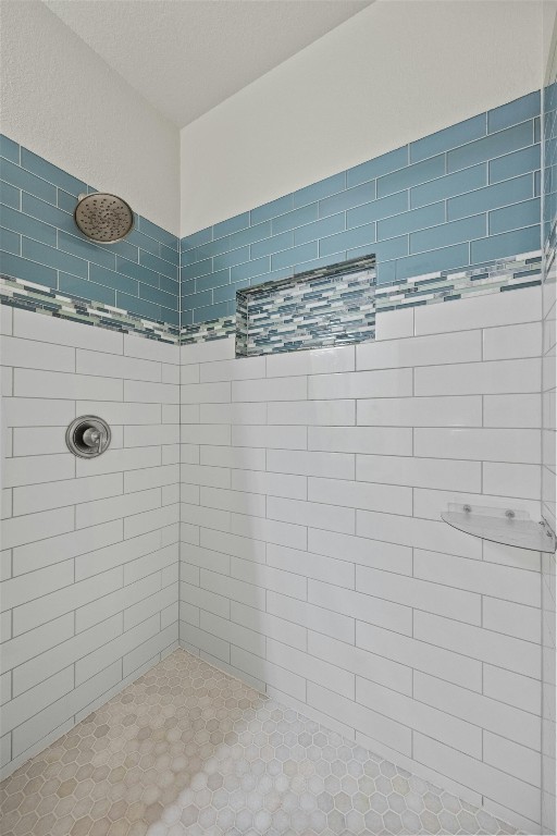 bathroom with tiled shower