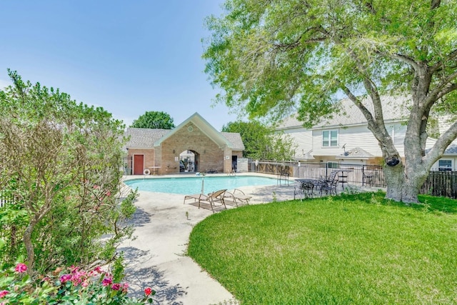 view of swimming pool with a yard and a patio