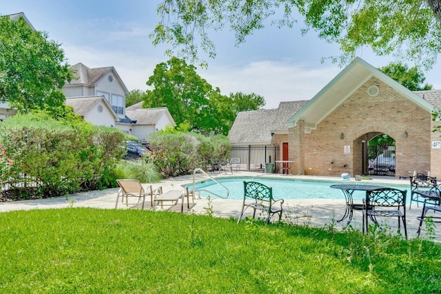 view of pool featuring a yard and a patio