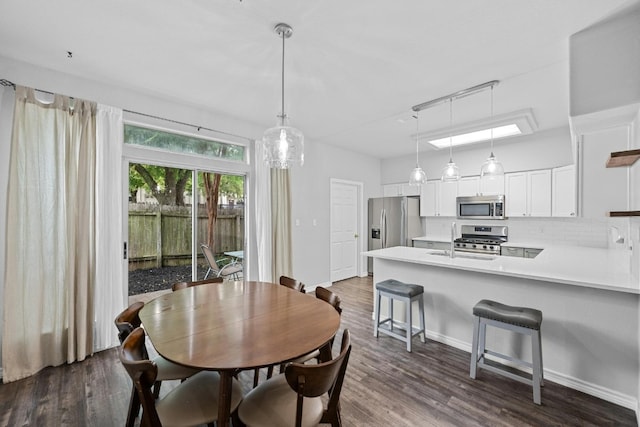 dining room with dark hardwood / wood-style flooring