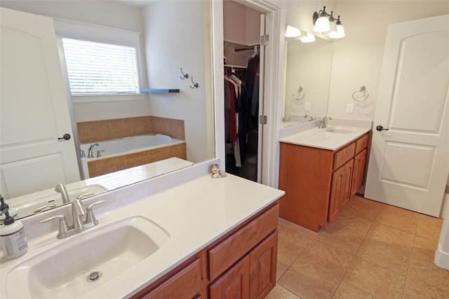 bathroom featuring vanity, tile patterned floors, and a bathtub