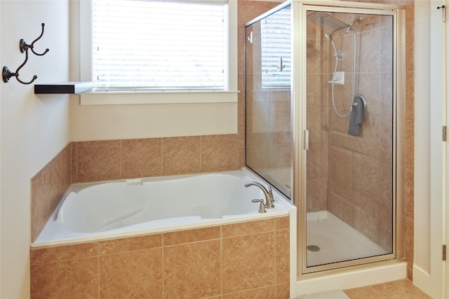 bathroom with separate shower and tub and tile patterned floors