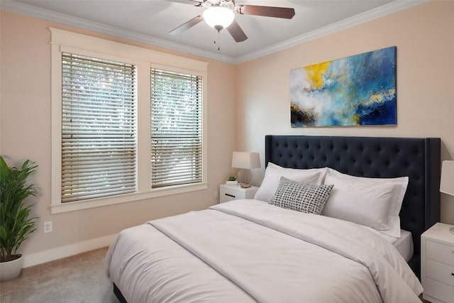 carpeted bedroom featuring ceiling fan and ornamental molding