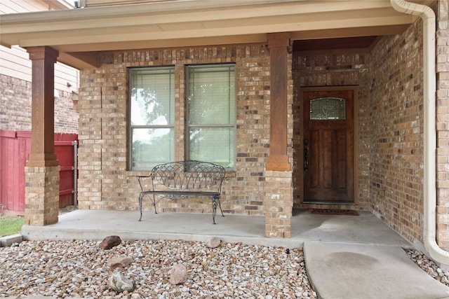 view of exterior entry featuring a porch