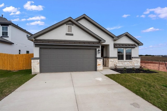 view of front of home with a garage and a front lawn