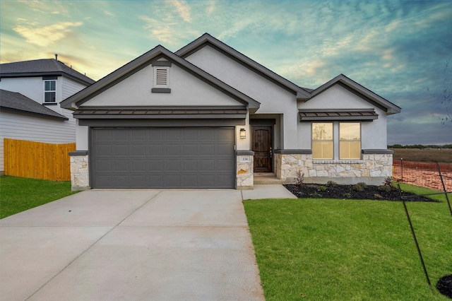 view of front facade with a garage and a yard