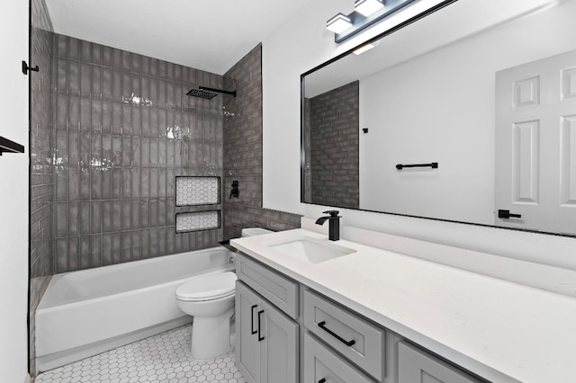 full bathroom featuring tile patterned flooring, tiled shower / bath combo, vanity, and toilet