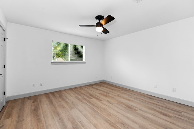 spare room featuring ceiling fan and light wood-type flooring