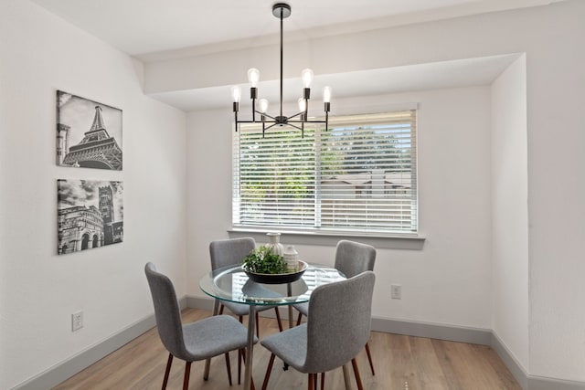 dining room featuring a notable chandelier and hardwood / wood-style flooring