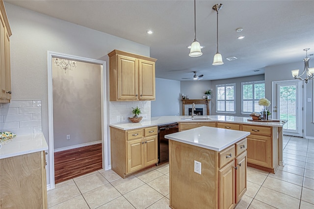 kitchen with a kitchen island, pendant lighting, dishwasher, sink, and kitchen peninsula