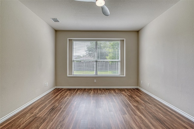 empty room featuring dark hardwood / wood-style floors and ceiling fan