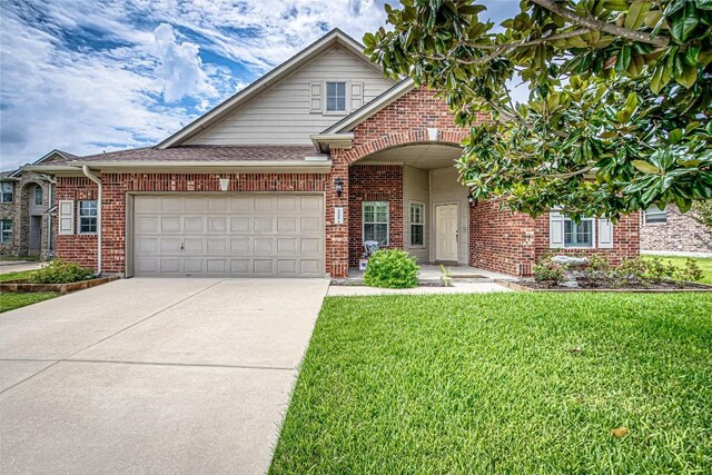 view of front of house with a garage and a front yard