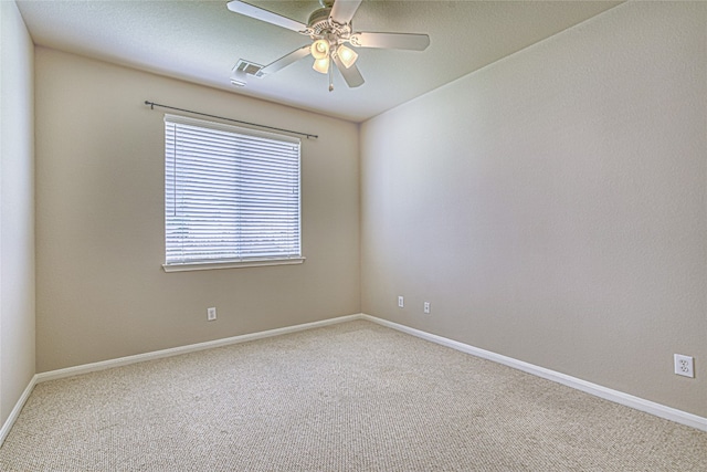 unfurnished room with ceiling fan and carpet flooring