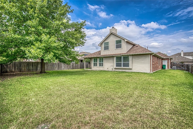 rear view of property with a lawn