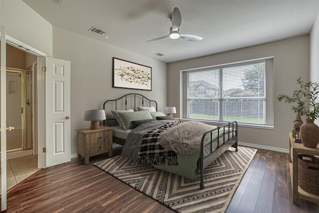 bedroom featuring ceiling fan, dark hardwood / wood-style flooring, and a textured ceiling