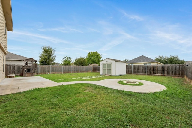 view of yard with a storage unit and a patio