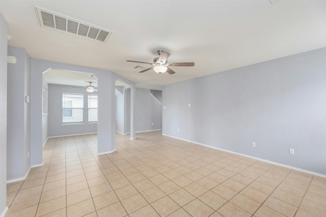 spare room with ceiling fan and light tile patterned floors