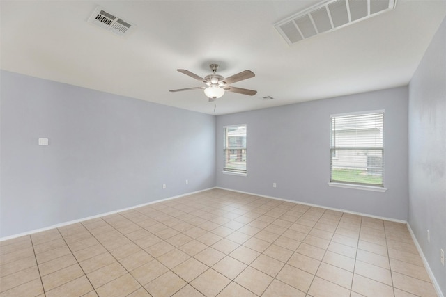 unfurnished room with ceiling fan and light tile patterned flooring