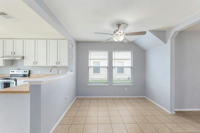 kitchen featuring white cabinets, light tile patterned floors, vaulted ceiling, stainless steel range with electric stovetop, and ceiling fan