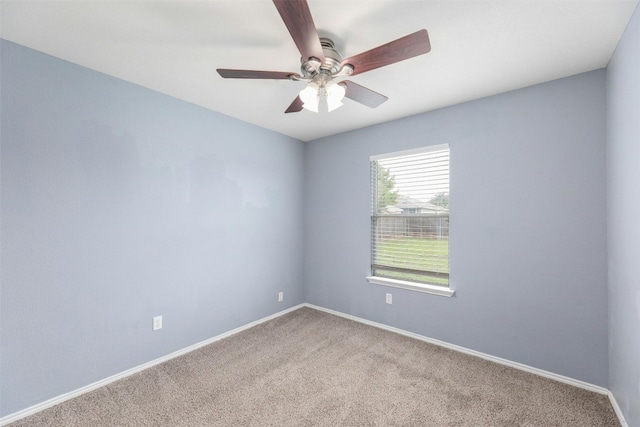 unfurnished room with ceiling fan and carpet