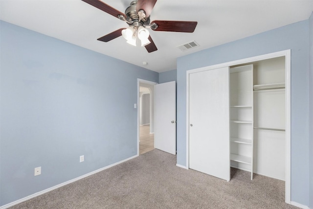 unfurnished bedroom with light carpet, ceiling fan, and a closet