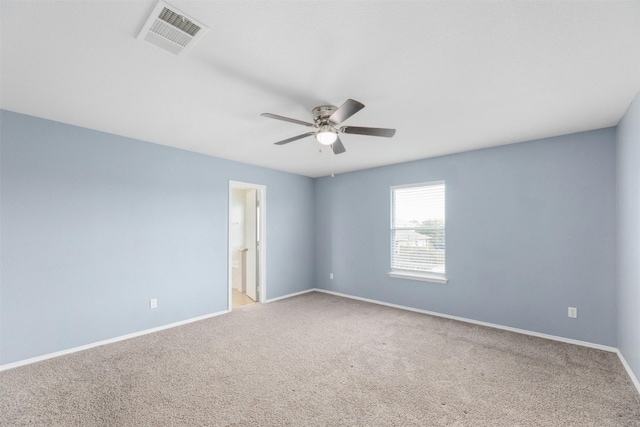 carpeted spare room with ceiling fan