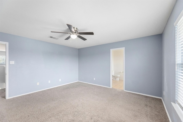 carpeted empty room featuring ceiling fan