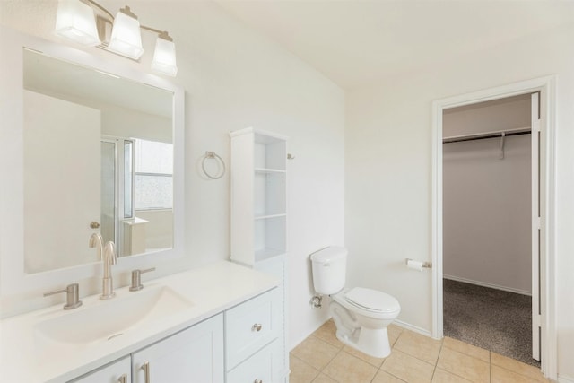 bathroom with vanity, toilet, an enclosed shower, and tile patterned floors