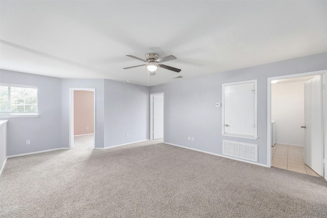 carpeted spare room with ceiling fan