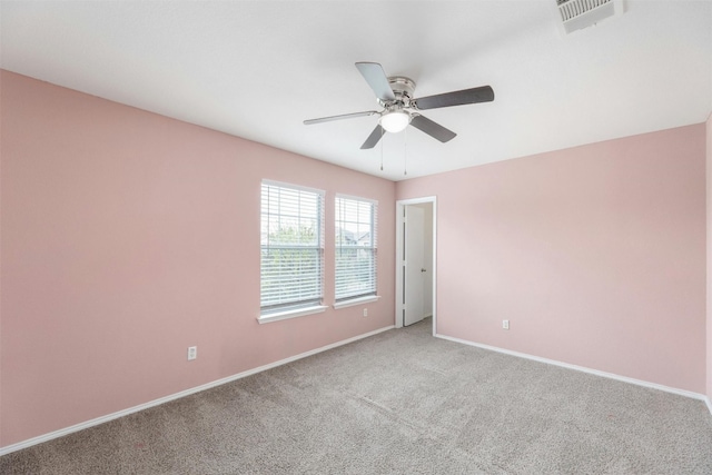 carpeted spare room with ceiling fan