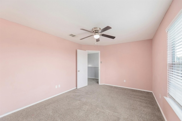 carpeted empty room with ceiling fan