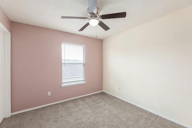 spare room with carpet and ceiling fan