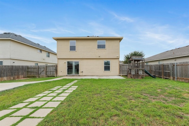 rear view of house featuring a playground, a patio area, and a lawn