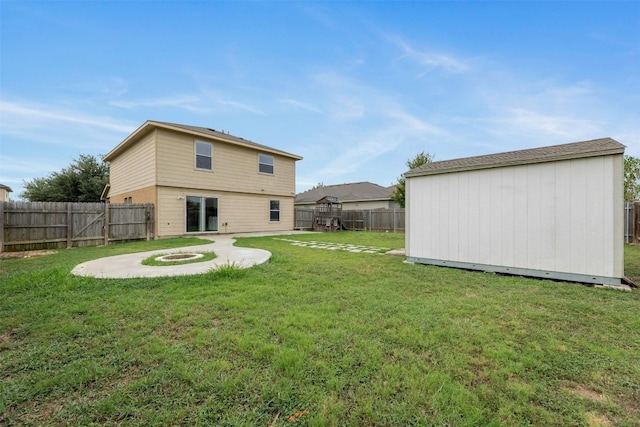 view of yard with an outdoor fire pit and a storage unit