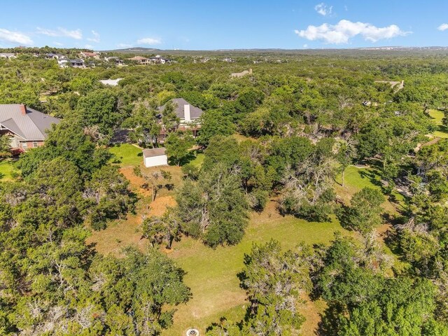 birds eye view of property with a view of trees