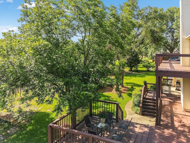 wooden terrace featuring a lawn