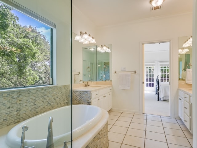 bathroom featuring french doors, tile patterned floors, vanity, tiled tub, and ornamental molding