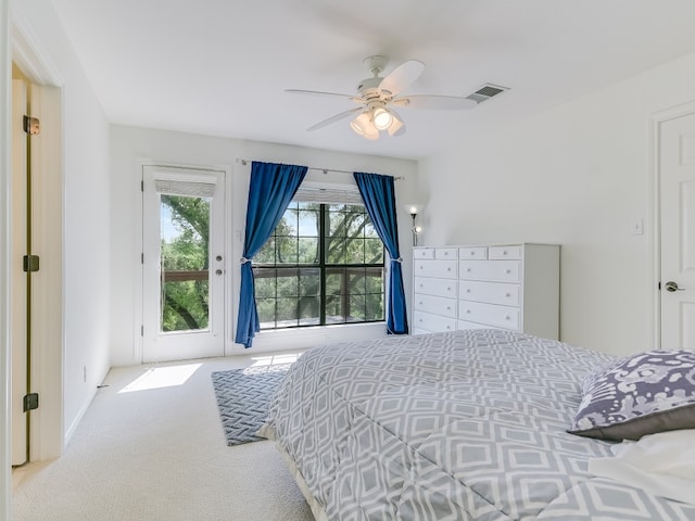 bedroom featuring light colored carpet, ceiling fan, and access to exterior