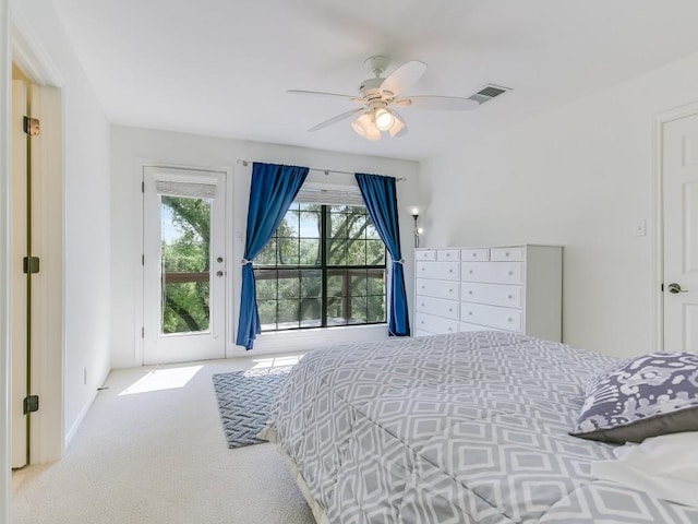 carpeted bedroom featuring visible vents, ceiling fan, and access to outside