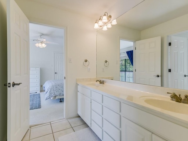 bathroom with tile patterned flooring, double vanity, a ceiling fan, and a sink