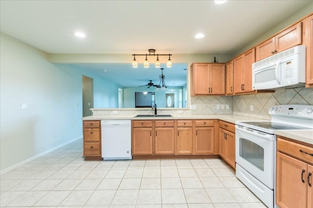 kitchen with white appliances, light tile patterned floors, kitchen peninsula, sink, and ceiling fan