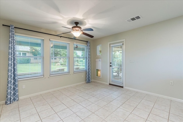 unfurnished room with ceiling fan and light tile patterned flooring