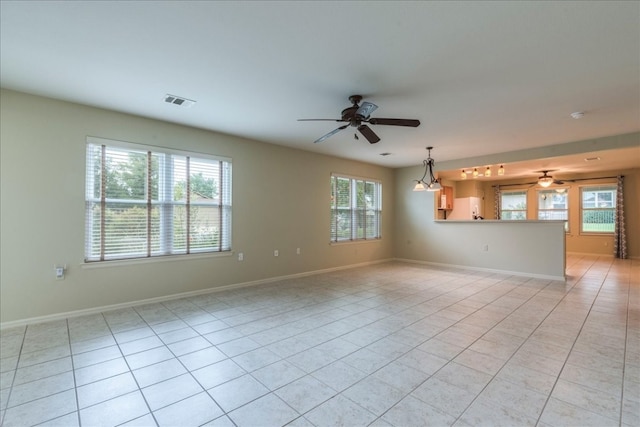 unfurnished living room with ceiling fan and light tile patterned flooring