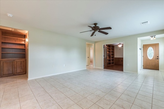 unfurnished living room featuring ceiling fan and light tile patterned flooring