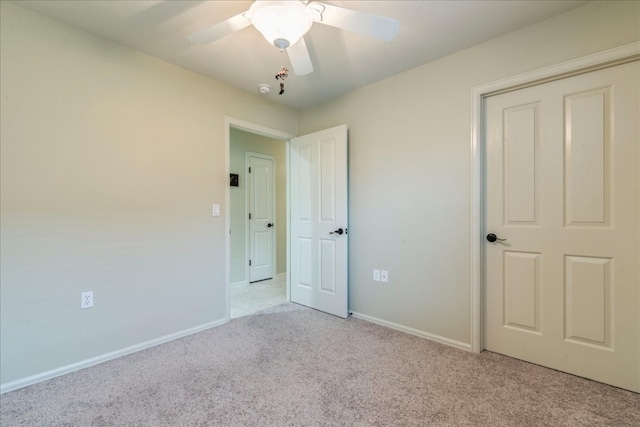 unfurnished bedroom with ceiling fan and light carpet