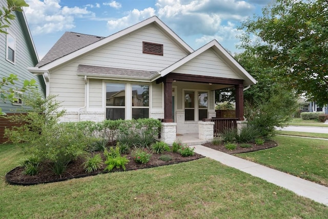 craftsman-style home with a porch and a front yard