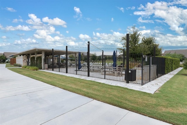 view of gate with a yard