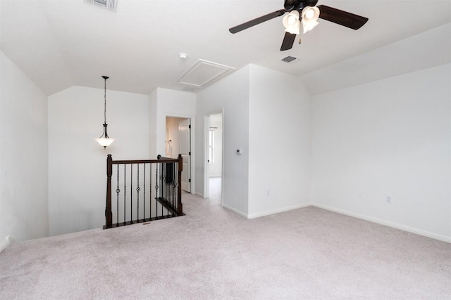 carpeted spare room with vaulted ceiling and ceiling fan